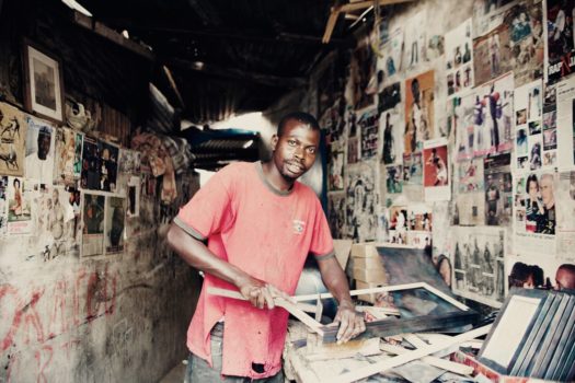 A man working on crafts to sell to tourists in Niaye Tchocker, a neighborhood in Dakar which is considered one of the slums.