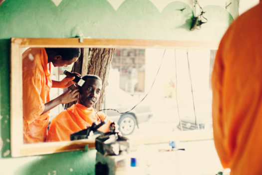 A man gets his haircut at a barber shop in Niaye Tchocker, a neighborhood in Dakar which is considered one of the slums.