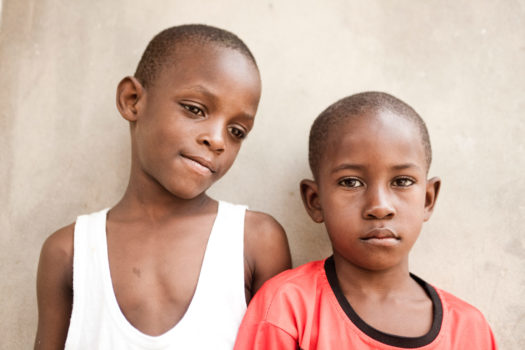 Two kids hanging out in their backyard in Medina, a neighborhood in Dakar