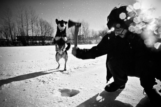 A Whole Village volunteer tests the ice on the community pond while McKenna, the farm dog, jumps for flying chips of ice. From the series 'Salt and Earth' 2008

© Jonathan Taggart
