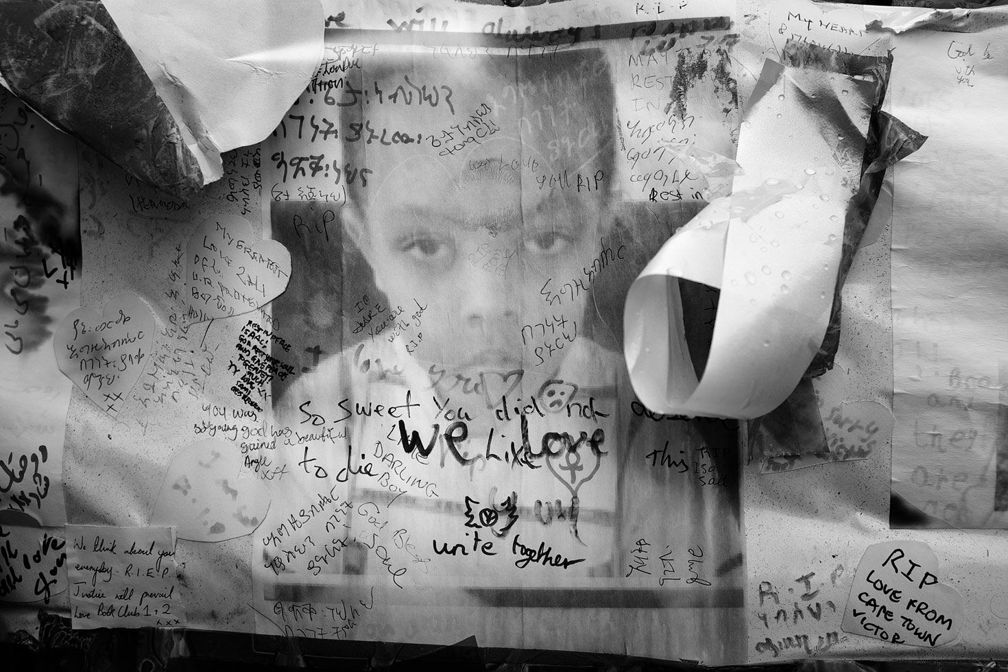 Photograph of victim Isaac Paulos, memorial wall, Bramley Road. Isaac lived on the 18th floor of Grenfell Tower.