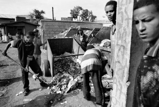 Bruke and Oromo clear garbage from a restaurant in exchange for scraps of leftover food.