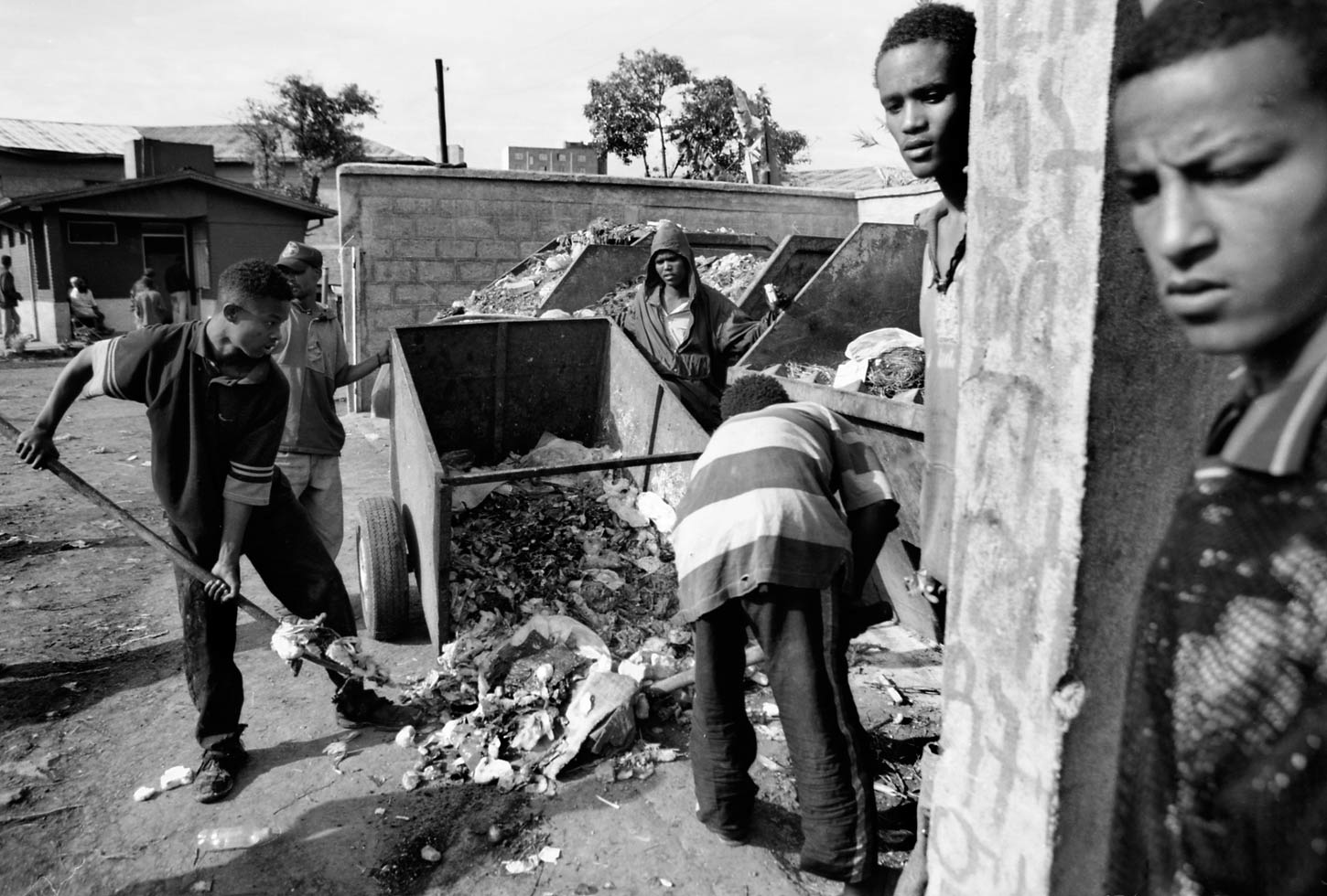 Bruke and Oromo clear garbage from a restaurant in exchange for scraps of leftover food.