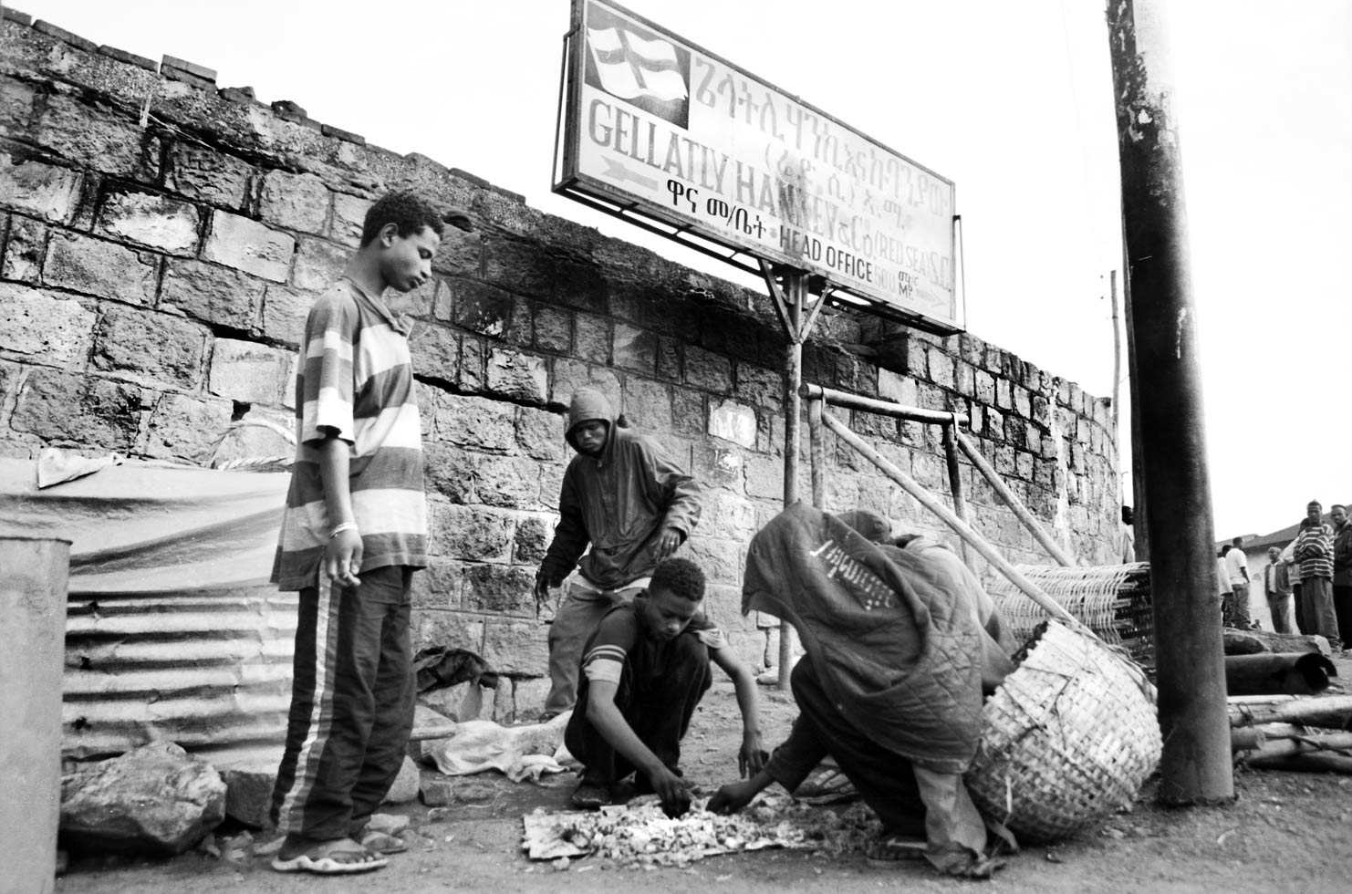 Bruke and his friends share scraps of leftover food that they are given in exchange for doing odd jobs.