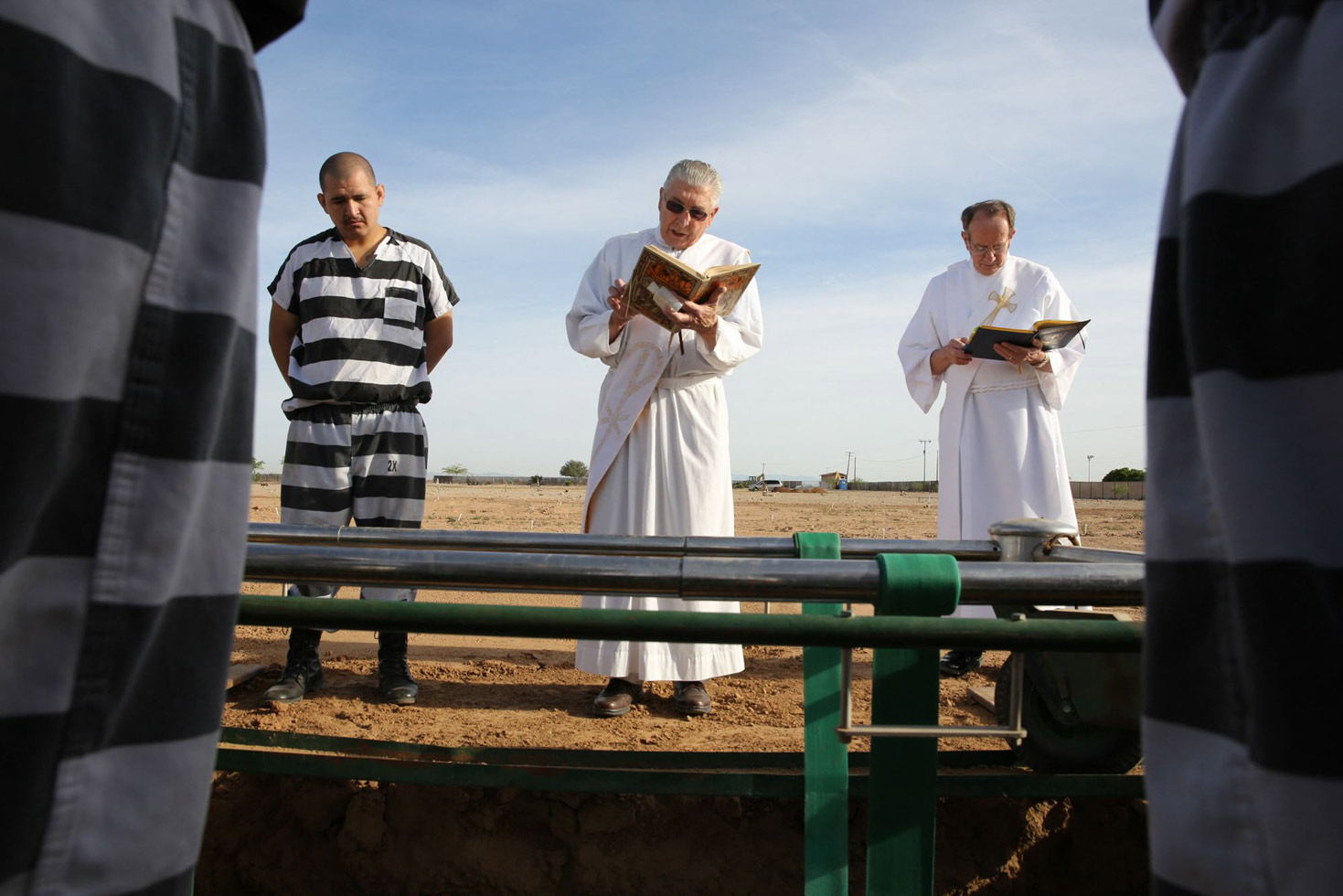Two priests and inmates perform burial duty at Whitetanks cemetery, near Phoenix.