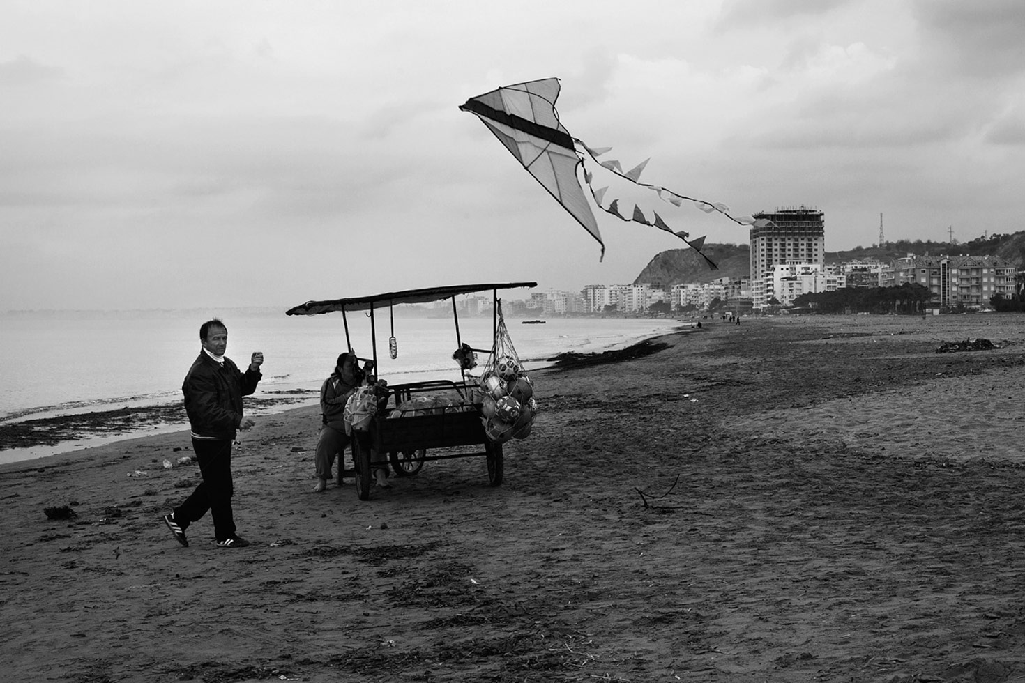 A couple selling their goods at the beach, even during winter months, when almost no-one visits.

Durres, Albania, 2012