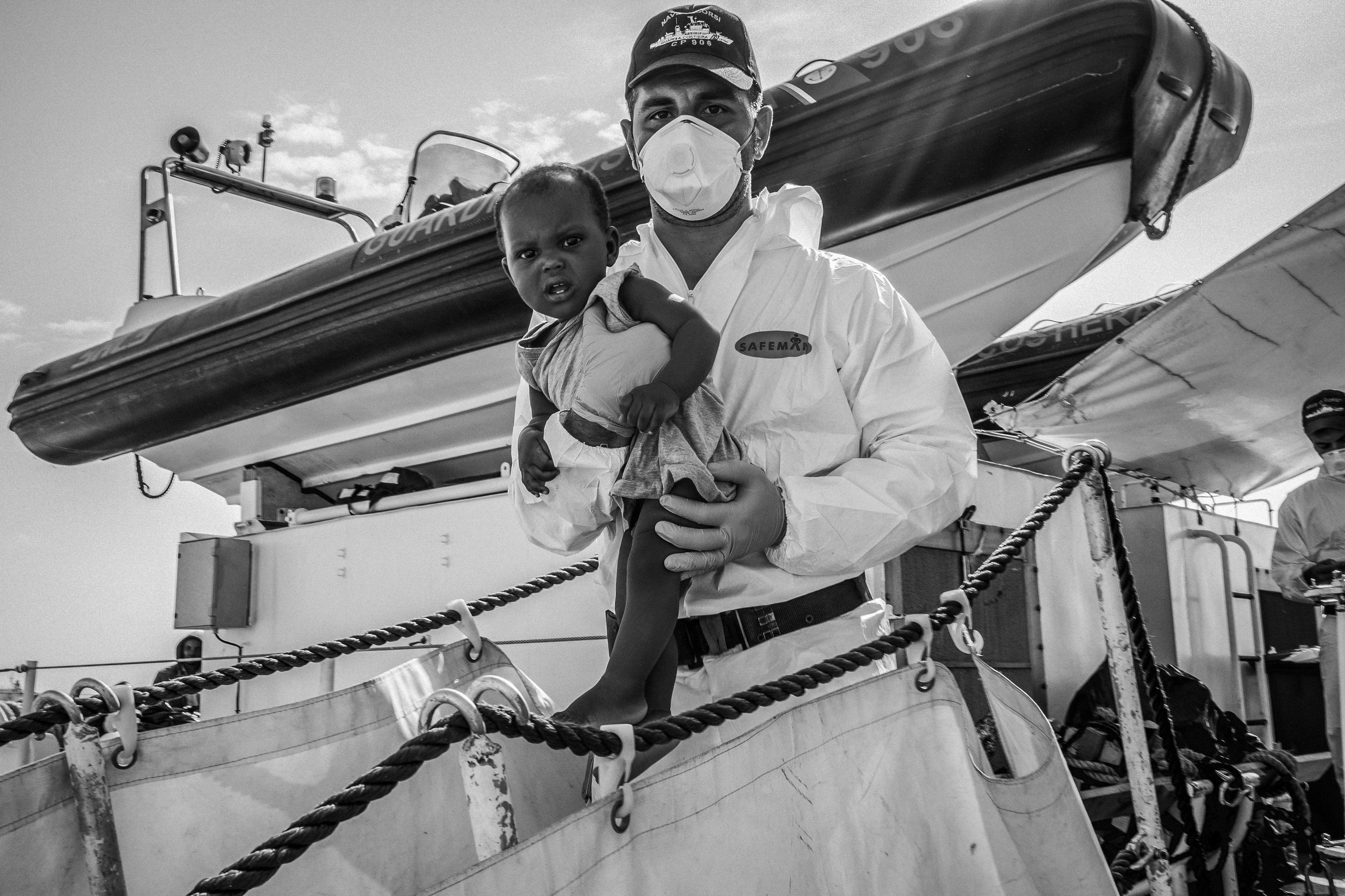 A small sampling of what Giles Clarke got up to in 2014.

An African refugee baby is carried ashore in Sicily having been picked up with 113 migrants who were found floating 30 miles off Libya.