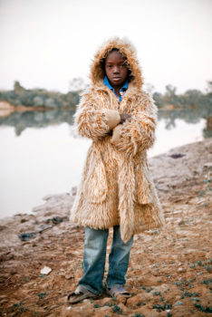The son of Bakary Dabo, the Alkalo of Diagabu Tenda, wearing a 'fur' coat on a cool morning.