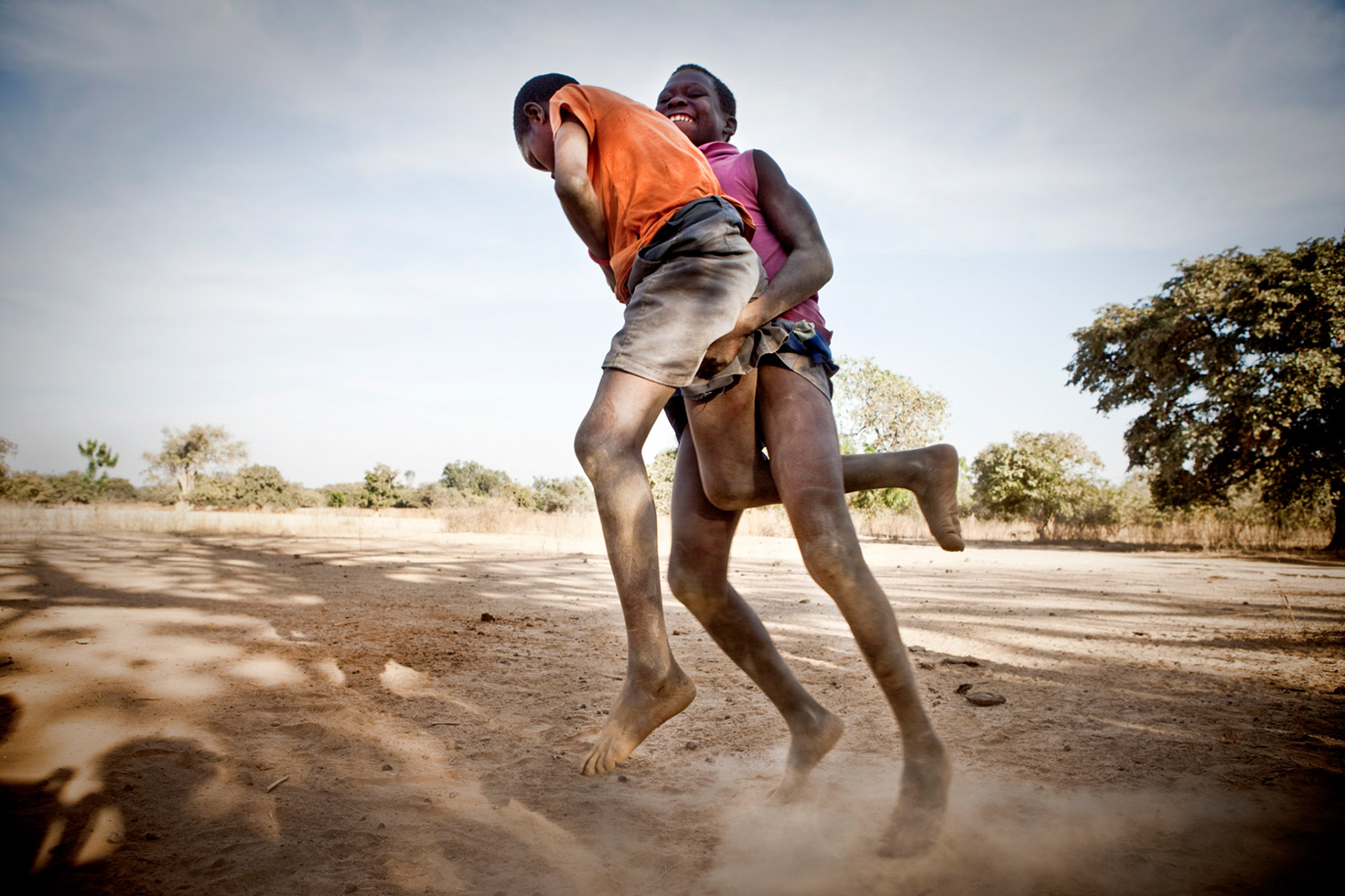 Young boys wrestling in a traditional Gambian style in the riverside village of Karantaba.