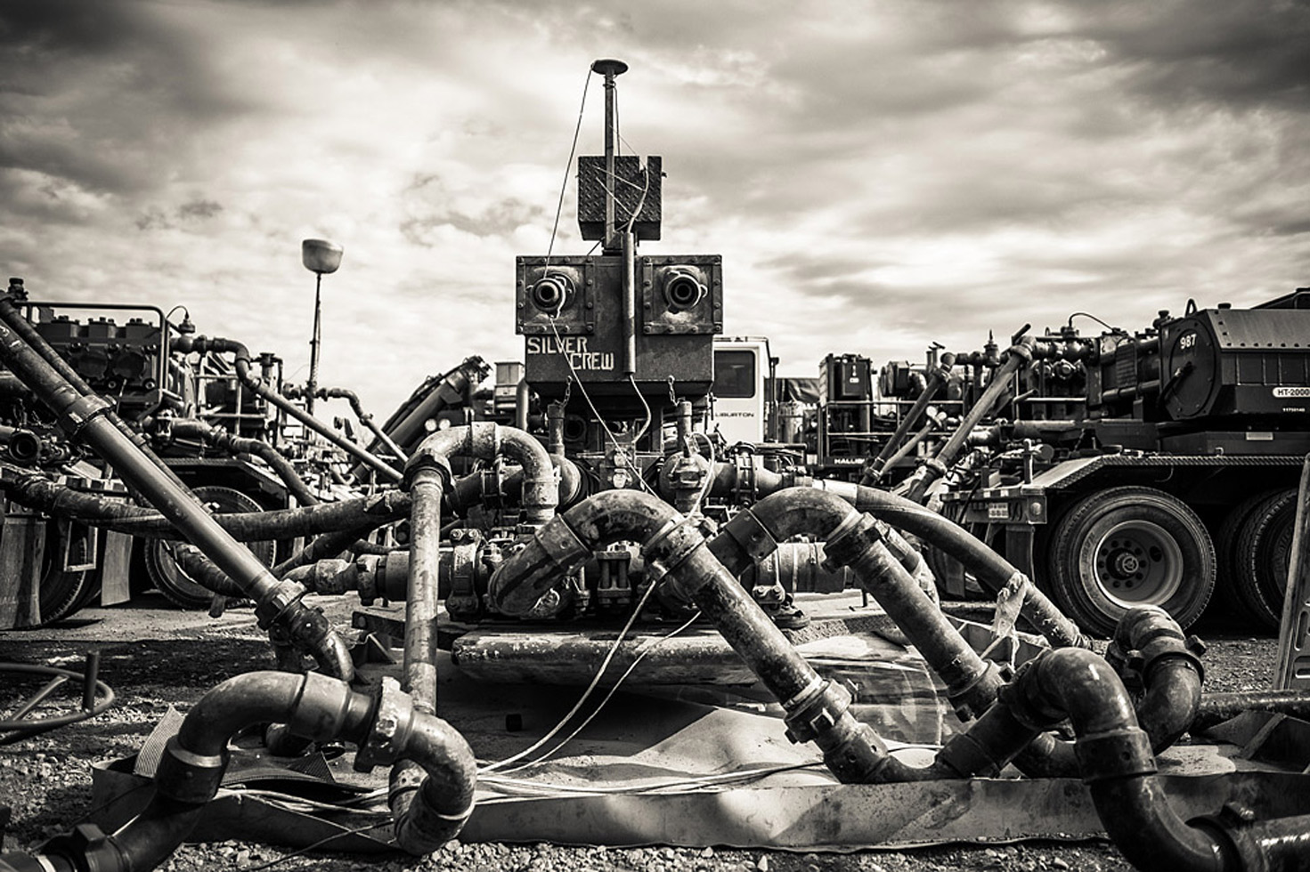 This is what fracking looks like from the surface. The pipes leading into the well head are connected to the trucks in the background. These trucks force water mixed with proppant - sand and tiny ceramic balls that keep the cracks propped open (hence the name) so that oil can flow towards the well pipe - and chemicals down into the well at 10,000 PSI.

Text and images by John Mireles