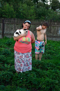 Mother and son in a strawberry patch