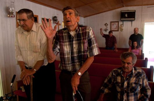 High Knob church in the hills outside of Iaeger. From left to right: Granville Mullens, also a pastor in the church, Ollie Bishop, and Riley Roberts. All three are former coal miners, all three have black lung disease.