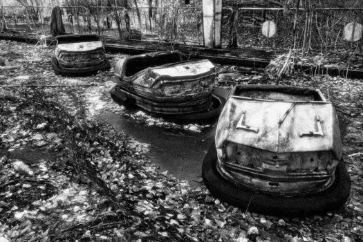 Like the Ferris wheel, these sad-looking bumper cars are left fading and rusting among radioactive moss.