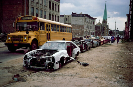 School bus and curbside crushed cars, Bushwick, Brooklyn, NY, 1985
