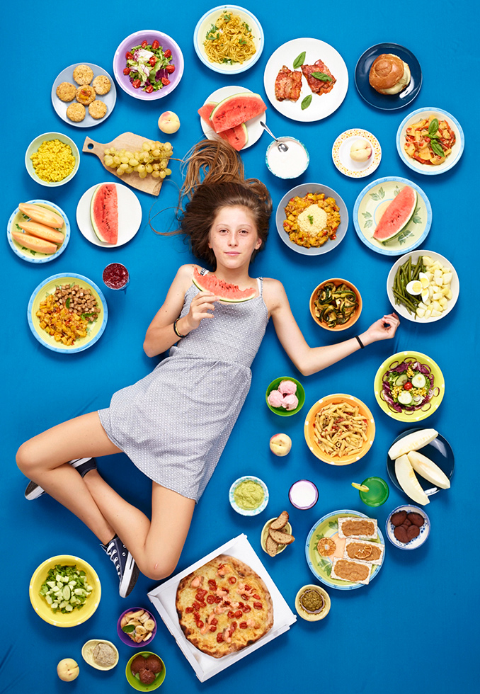 Traveling the world looking at how globalization alters our relationship to food, Gregg asked his subjects, all children, to keep a journal of everything they eat in a week. He then makes a portrait of the child with the food arranged around them. 

Amelia Torrisi, 12, Trecastagni, Sicily, photographed August 23, 2017