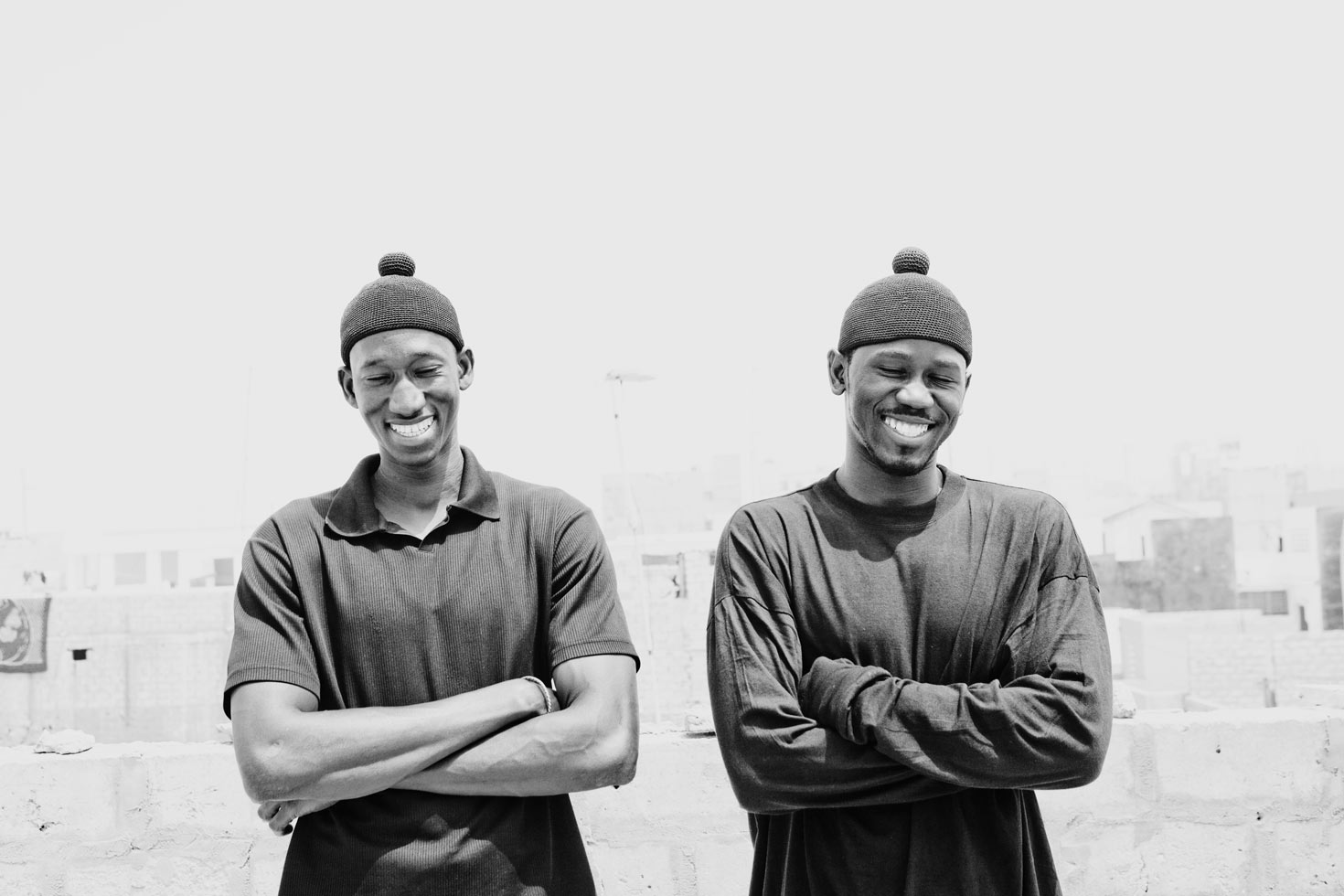 Haddim and Maguet laugh on a roof top near Yoff Layene, a neighborhood of Dakar