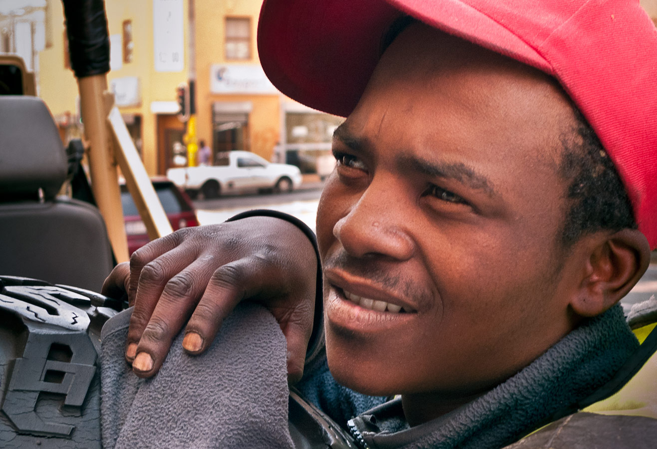 A young man who makes his living guarding cars. Braamfontein, Johannesburg.