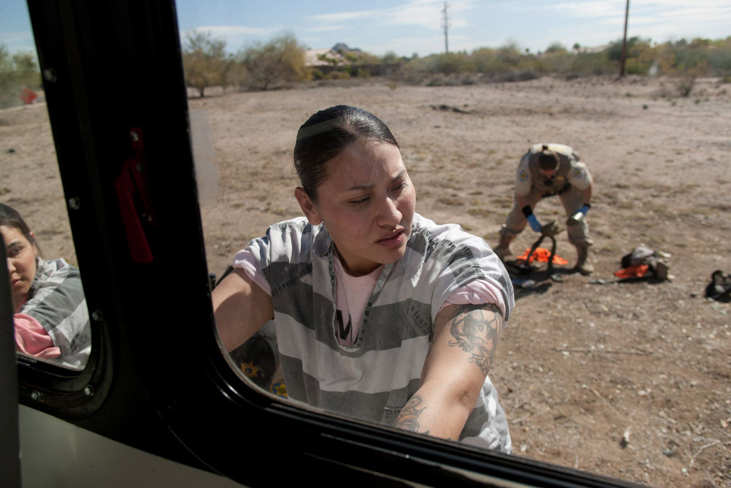 A female inmate is searched for contraband.