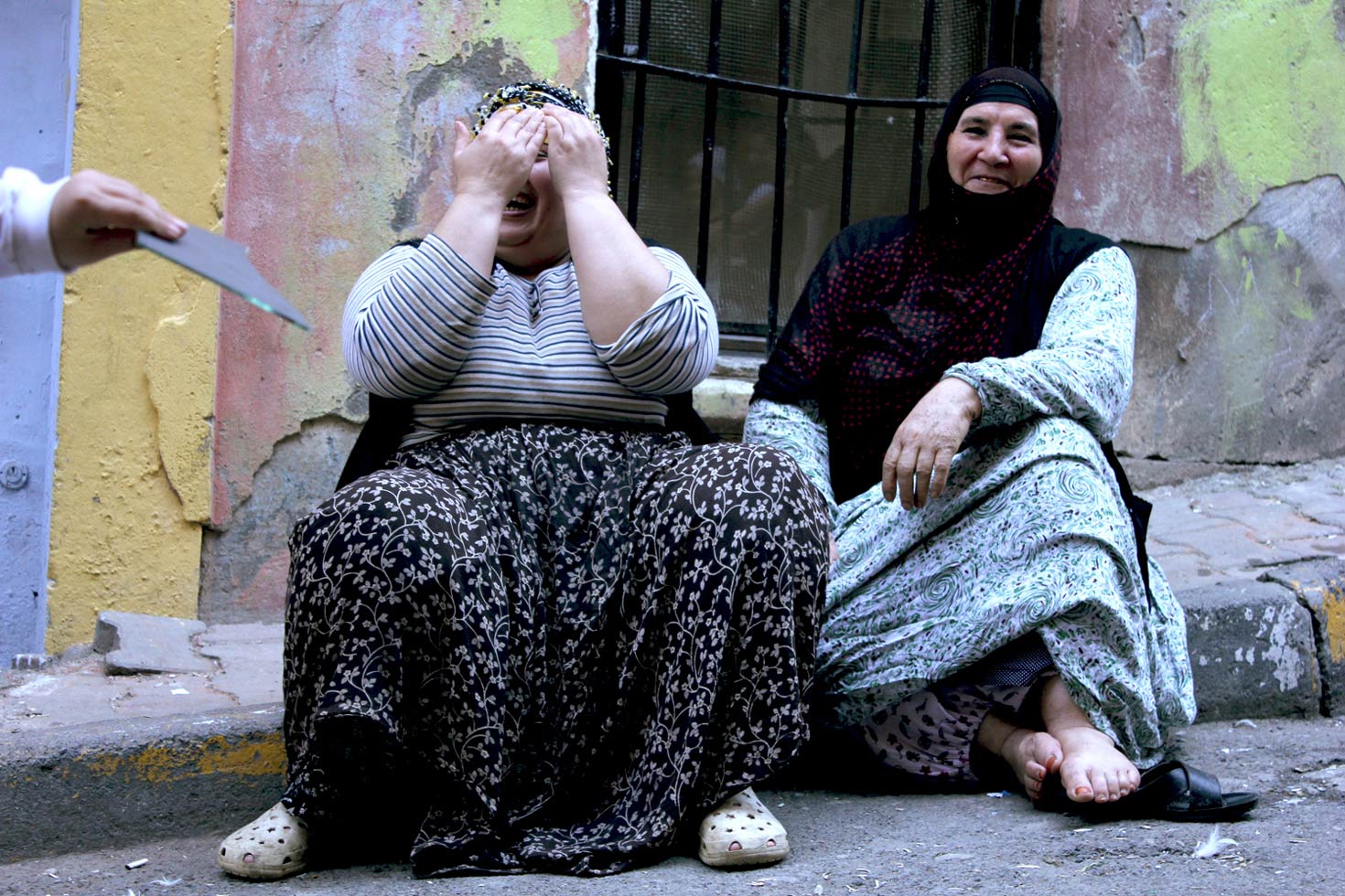 Kurdish women taking a break from their work preparing mussels.