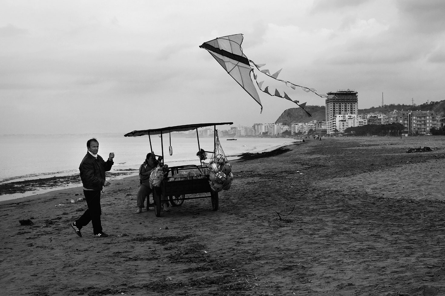 A couple selling their goods at the beach, even during winter months, when almost no-one visits.

Durres, Albania, 2012
