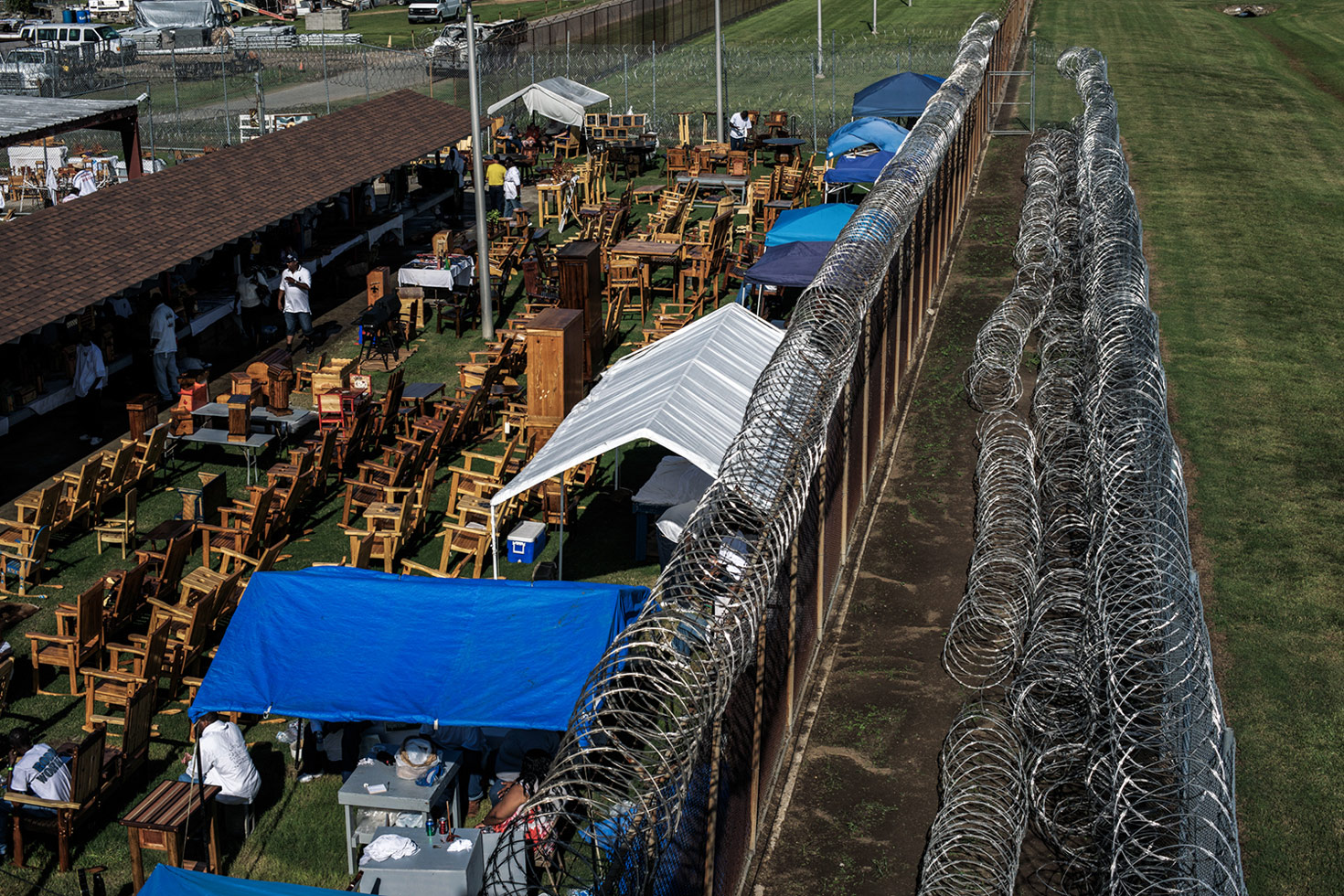 The view from a guard's tower over part of the craft section within the prison rodeo site. The prison has an entire manufacturing industry producing furniture, mattresses, brooms, and many other well-used items that keeps the Angola residents busy. 