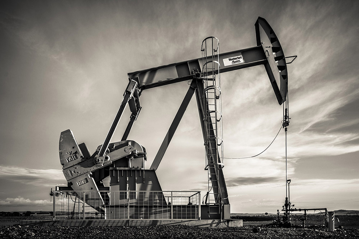 The ubiquitous pump jack is basically a large plunger. At the end of four miles of pump rod lies a ball that sucks up oil and water from the fractured shale and works it up to the surface where it's separated and stored in large tanks to await transport.