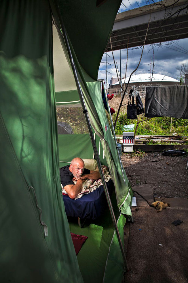 When I first met Russell he was living inside a bridge. When he moved to this camp he had a wooden shanty until the neighboring business donated a tent and a cot. He says this is the best home he has ever had.