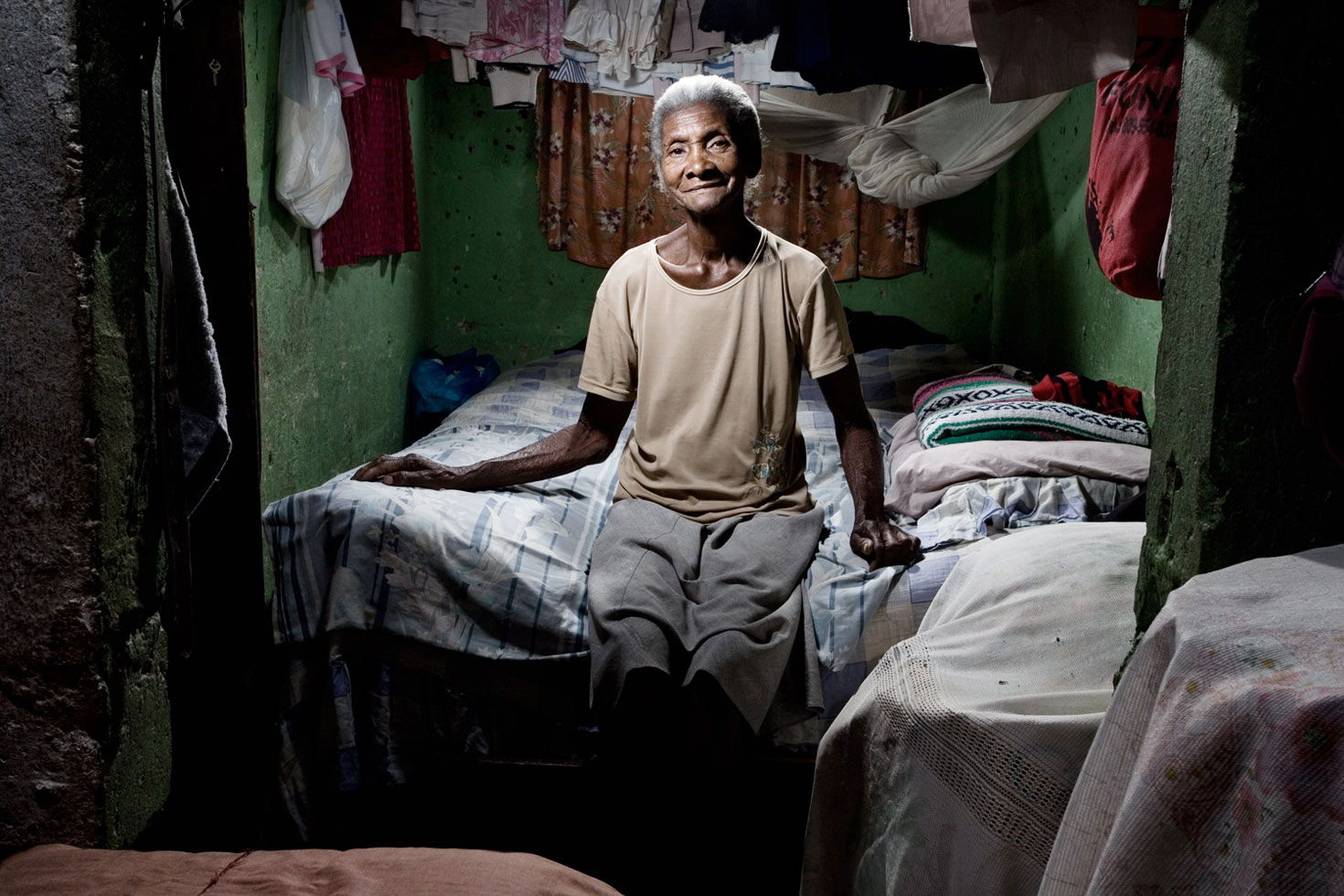 Felicia raises three of her grandchildren. The family was supported by her husband's pension until three months ago when he passed away. She lives in one of the few barracks that survived Hurricane George.