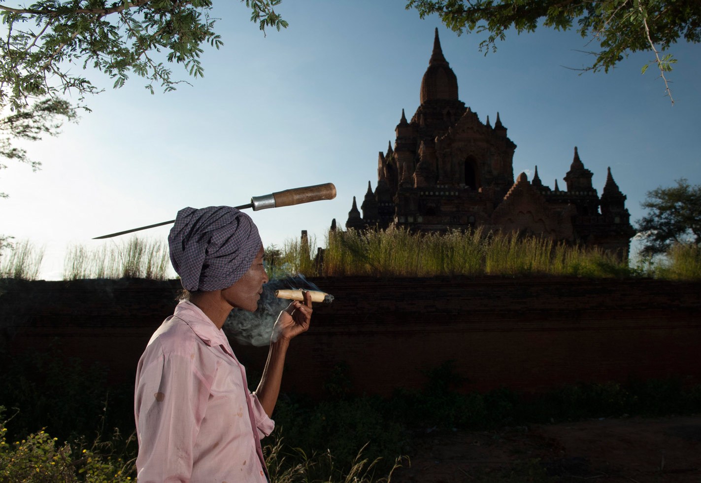 Bagan, Myanmar, 2011
"Daw Thaw Yin, 53 years old, is a single mom with two children, whose husband died 20 years ago from stomach complications. She prefers to carry the machete on her head, and uses it to cut firewood that she sells. She smokes 3 cheroots (one large and two small) a day."