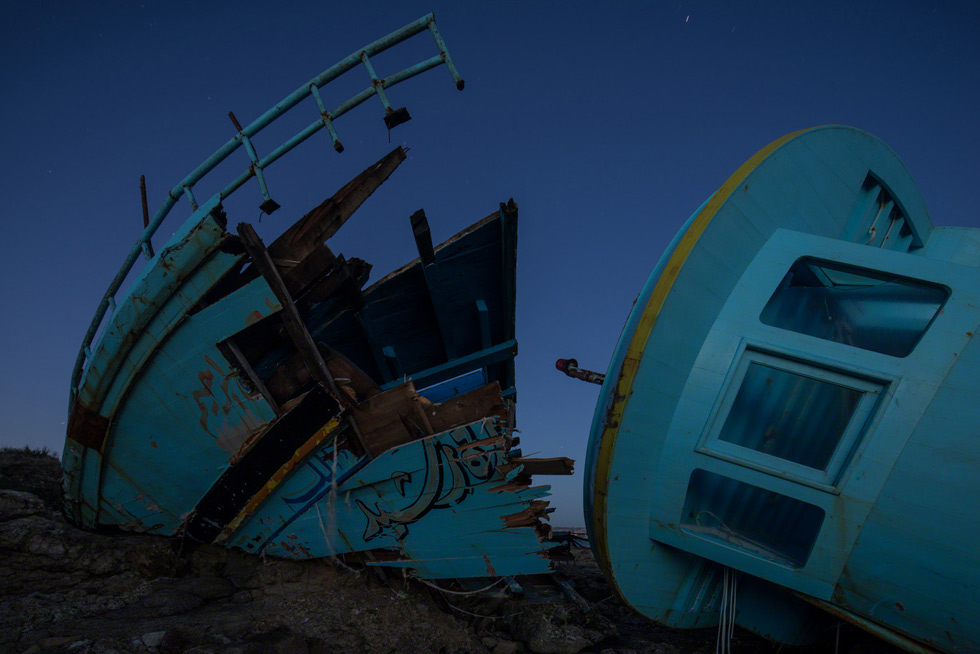 August, 2013, a boat lands on the rocks off Siracusa, Sicily.