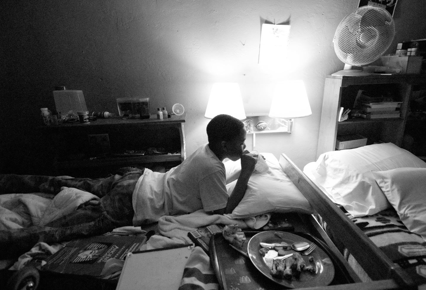 With no room for a kitchen table, Shaheed, Denise and Mahir eat, work and sleep on their beds.