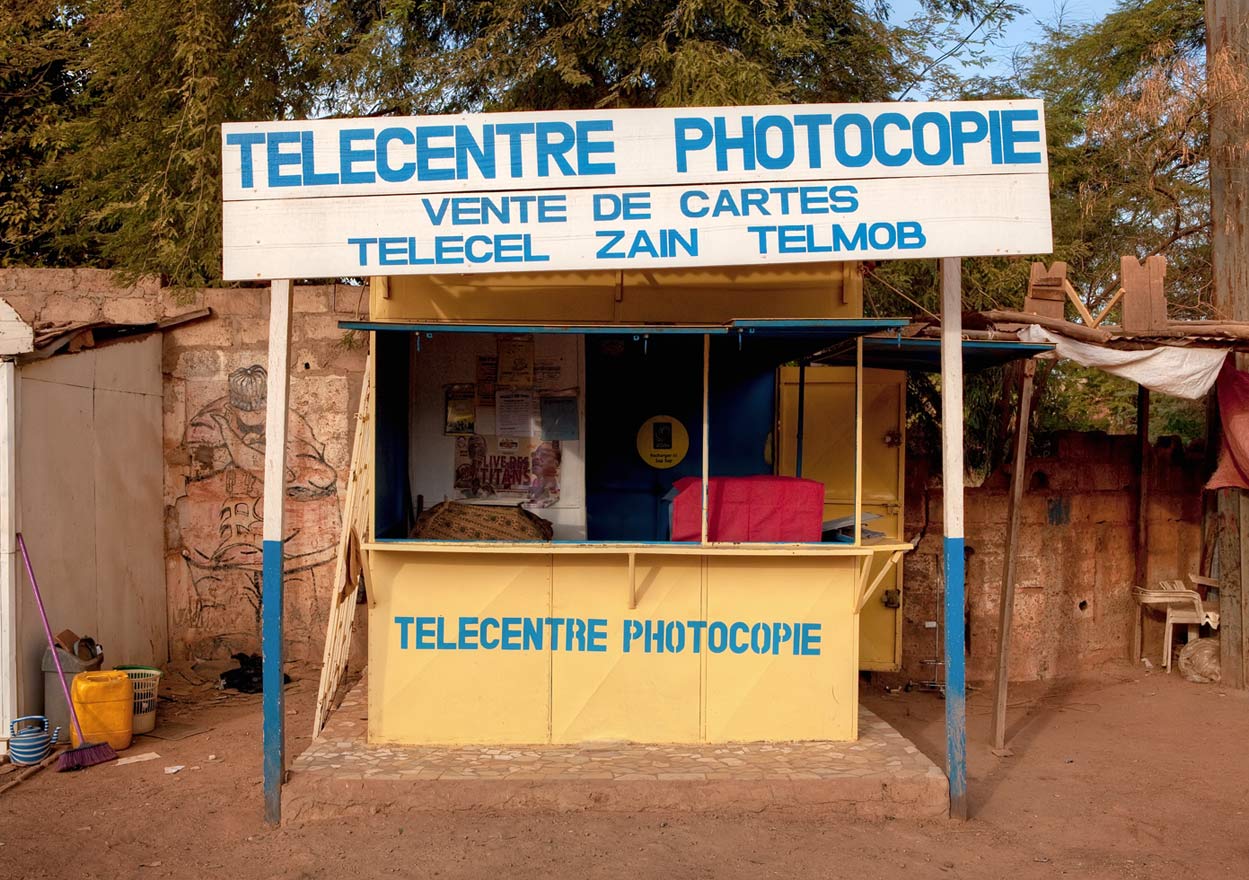 They photocopy documents, recharge cell phones and repair bicycles. At mid-day the kiosks are surrounded by neighbors and customers.
