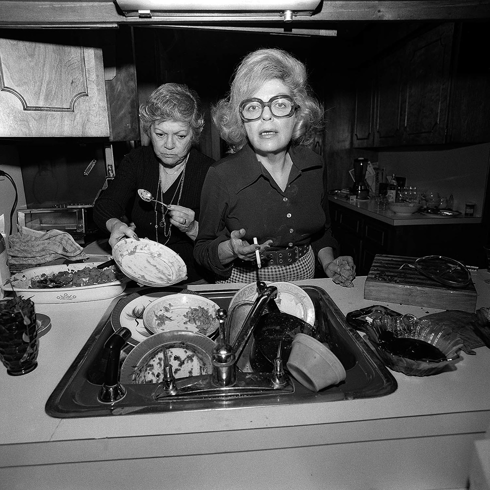 “Enough with the pictures” Mom and Aunt Evelyn doing Thanksgiving dishes, North Massapequa, 1975