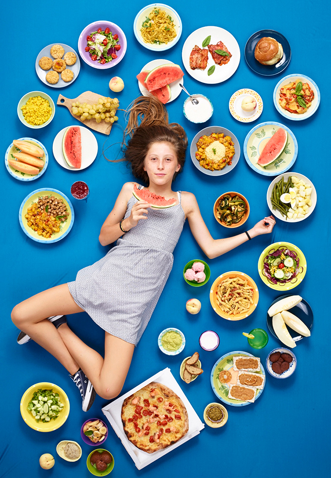 Traveling the world looking at how globalization alters our relationship to food, Gregg asked his subjects, all children, to keep a journal of everything they eat in a week. He then makes a portrait of the child with the food arranged around them. 

Amelia Torrisi, 12, Trecastagni, Sicily, photographed August 23, 2017