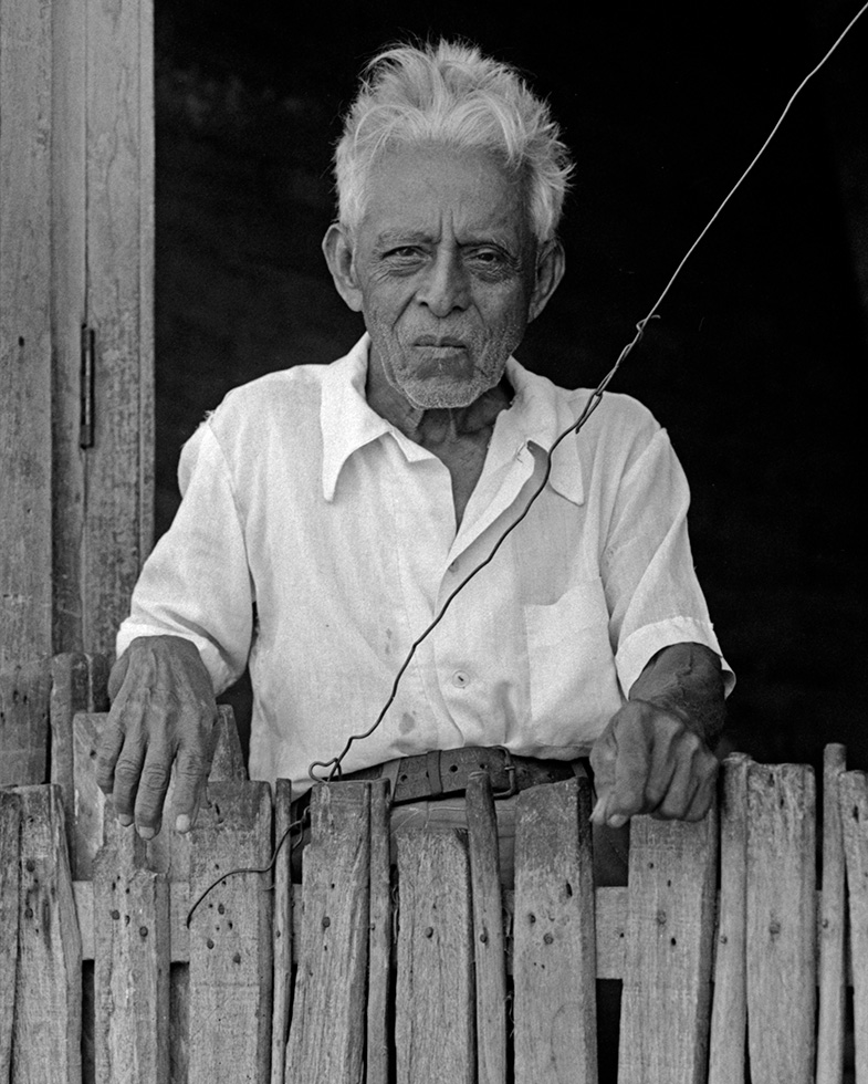 Jose. Jose was standing in his doorway watching a political demonstration when I caught sight of him. I motioned to my camera and pointed to him, and he graciously nodded his approval.